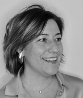 Mujer sonriente con auriculares en un entorno profesional.